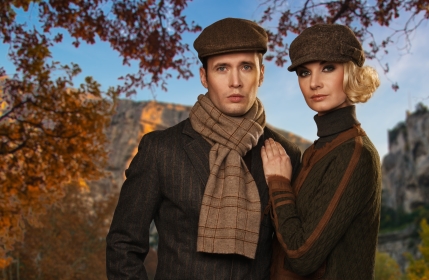 Elegant couple in caps against autumnal landscape Fall fashion